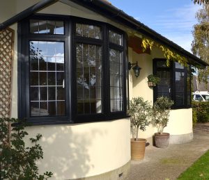 Black aluminium bay window with leaded glazing