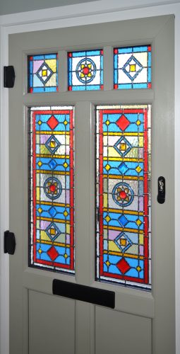 Multi-coloured stained glass in a door.